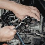 Mechanic tightening engine bolt